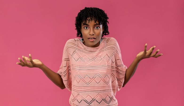 Young woman expressing confusion or uncertainty with a puzzled look.