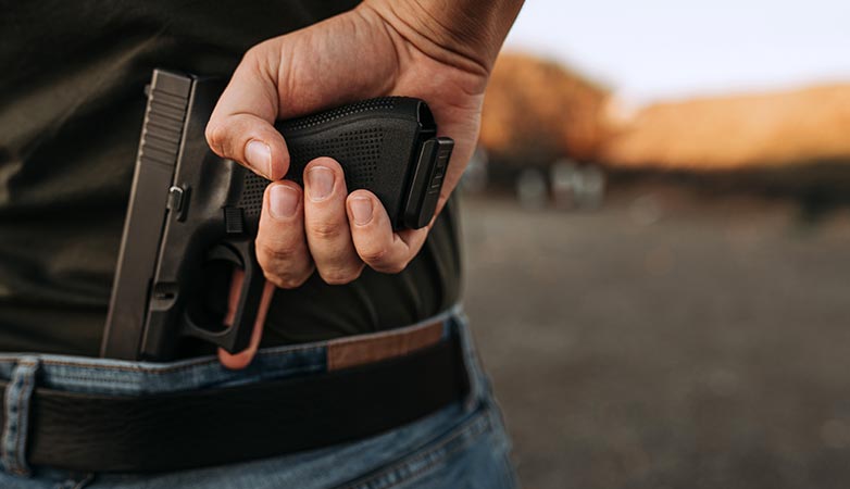 Man pulling out a gun.